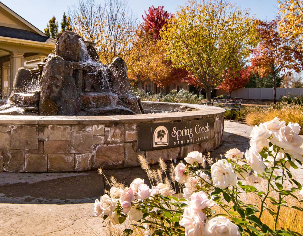 spring creek senior living sign affixed to fountain