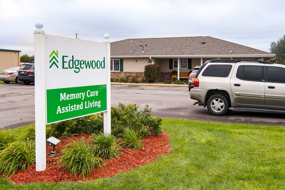 outdoor sign with Edgewood logo stating Memory Care Assisted Living