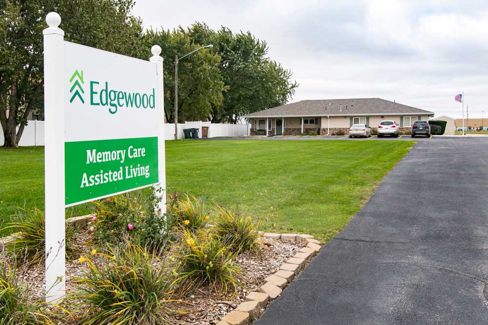 outdoor sign with Edgewood logo stating memory care and assisted living