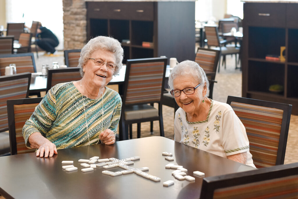 two senior women playing dominos