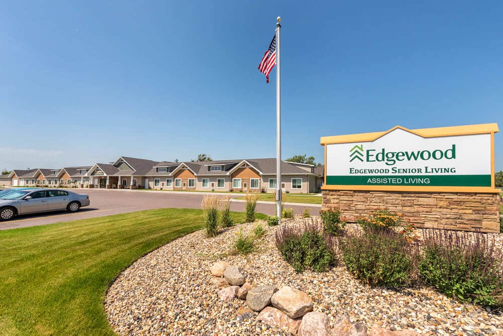 exterior sign with Edgewood logo stating Edgewood senior living and assisted living