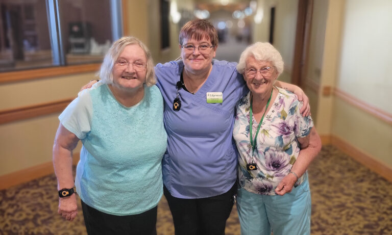 Senior living residents and staff wearing watches with proactive health tracking capabilities.