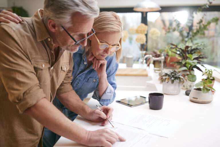 Mature couple reviewing long-term care insurance policy