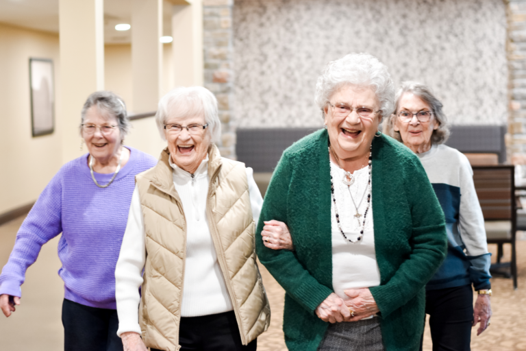 Senior ladies walking arm in arm as a group