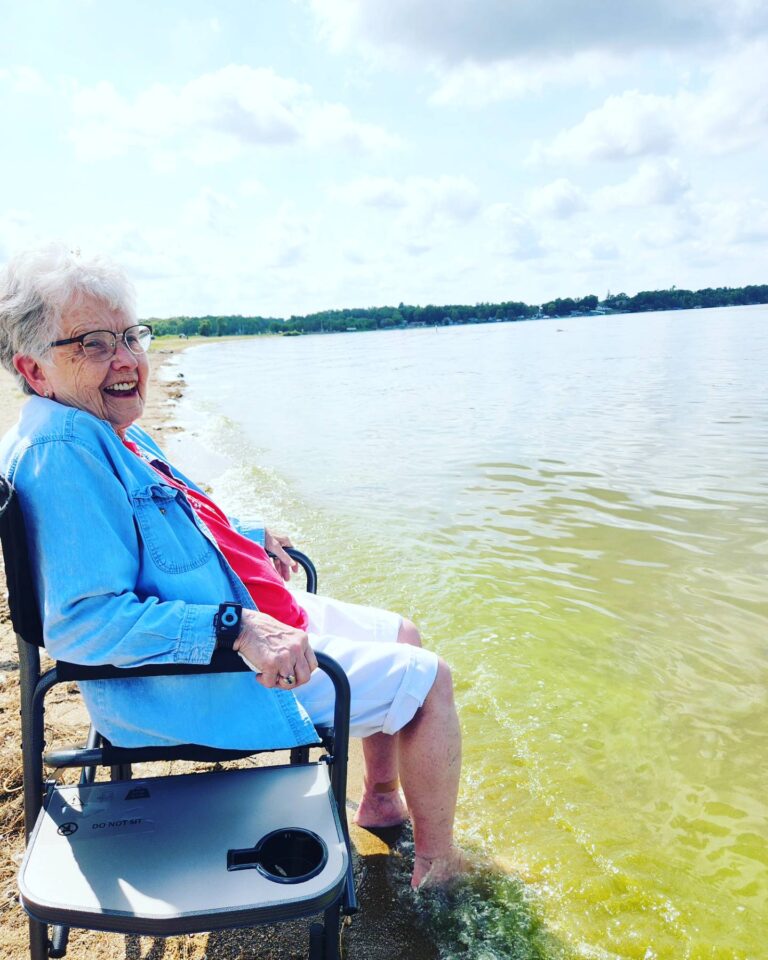 Senior female with toes in the water